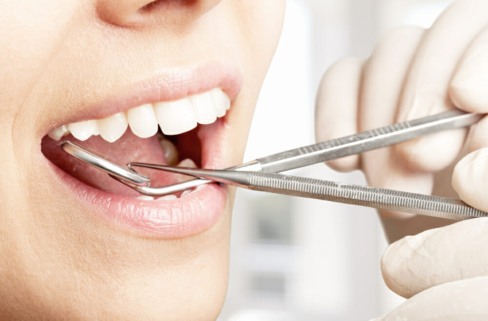 Smiling woman under dental treatment