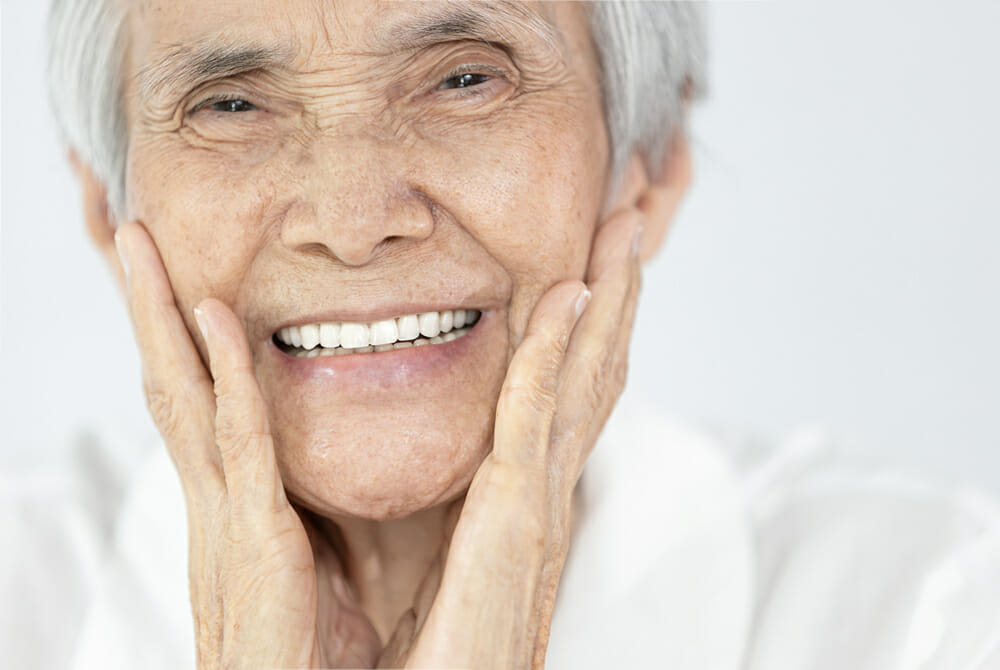 A beautiful old woman smiling with her perfect teeth
