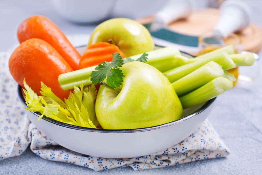 Bowl of apples, carrots and celery