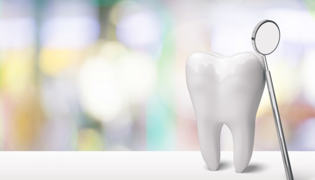 dana-st-dental-first-visits | Dana Street Dental A large white tooth with a dental mirror beside it in a blurred clinic background, symbolizing dental checkup
